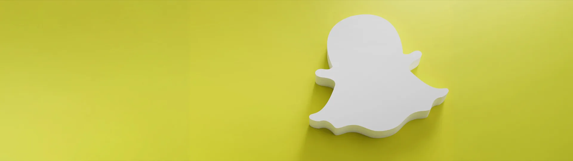 White 3D Snapchat ghost logo on a yellow background