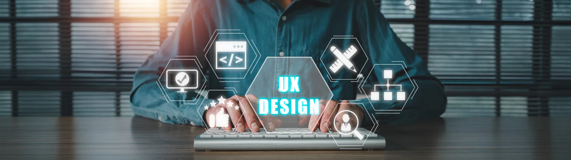 Designer typing on a keyboard behind glowing UX Design icons for code, wireframes, testing and user research